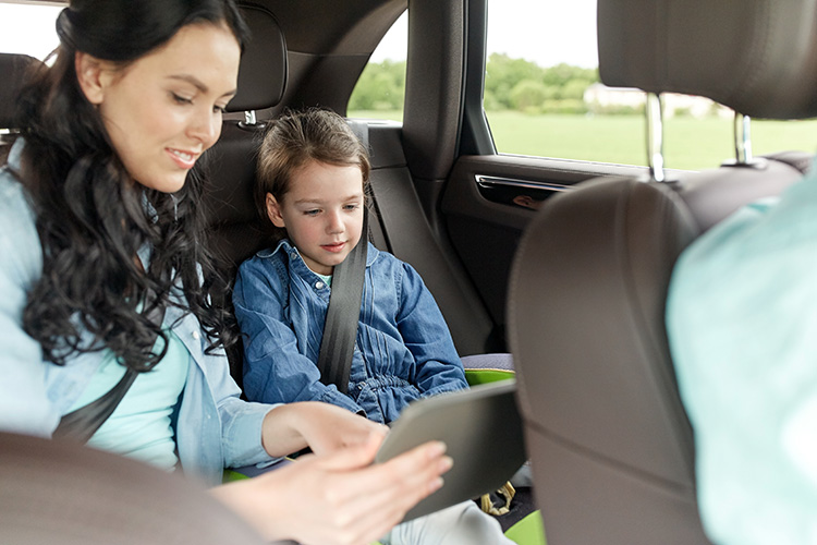 two kids sitting in the back of a car boot