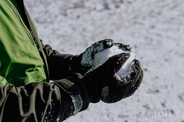 snow-gloves a kid wearing snow gloves holding a snowball